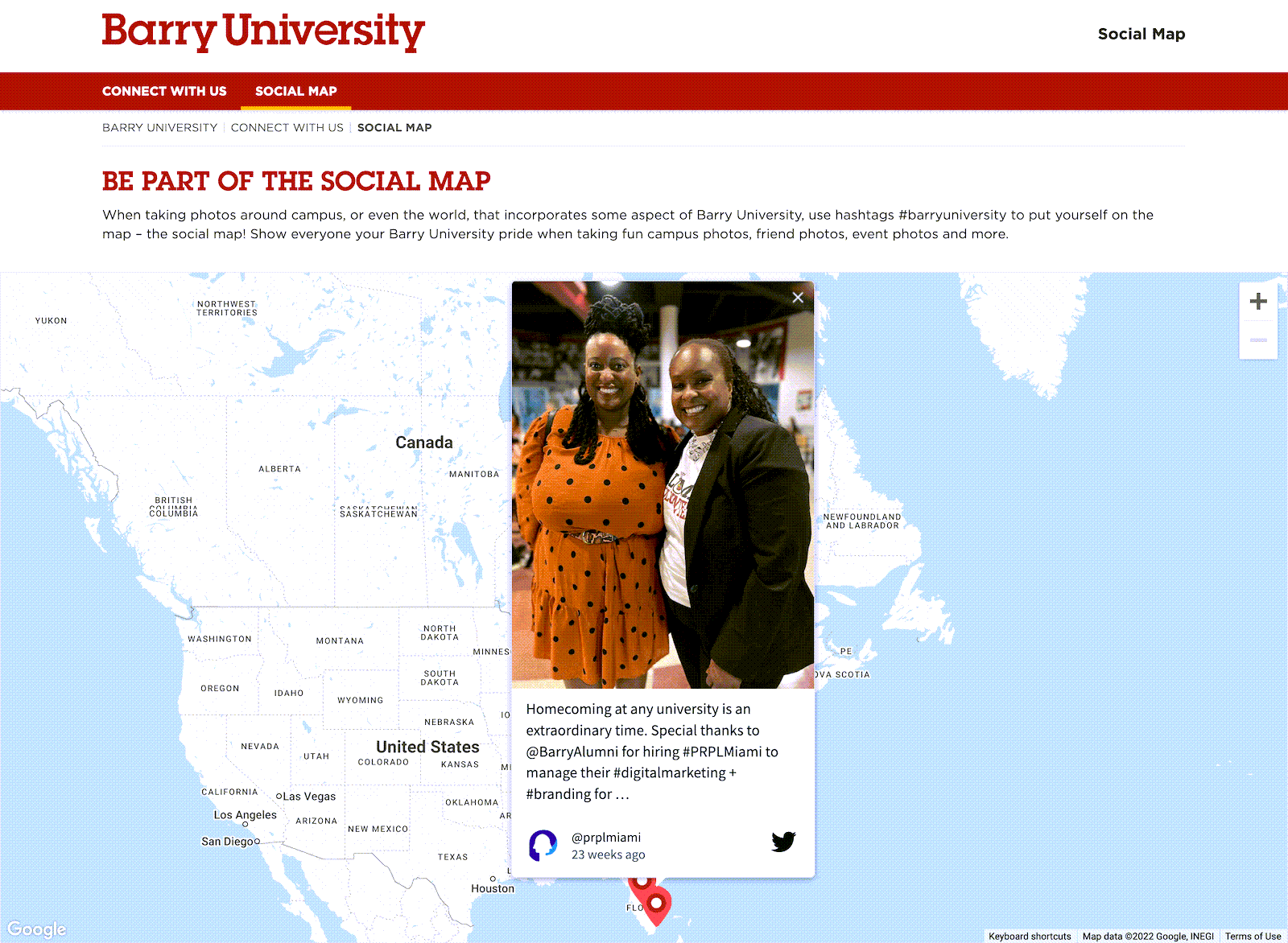 Two women smiling and posing together in front of a Barry University social map pin, celebrating a homecoming event and a digital marketing role with PRPL Miami.