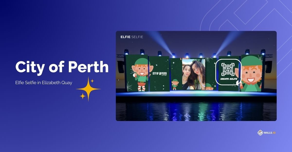 Social wall by the City of Perth displayed outdoors during a christmas light festival. The wall features a QR code for people to submit Elfie Selfies.
