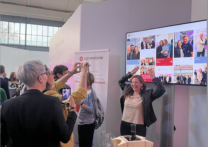 People interacting at an event thanks to a social wall.